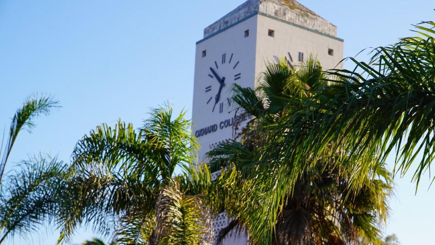 Oxnard College clock tower with palm trees in the foreground