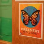Sign on a door with a butterfly and the text "Dreamers Welcome"