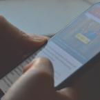 A person viewing a news website on their cell phone. 