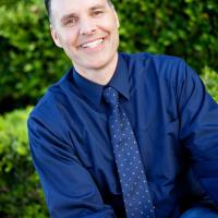 Dr. Steve Hall outdoors wearing buttoned shirt and tie