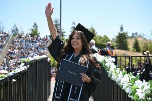 A graduate from Moorpark College wearing a cap and gown with