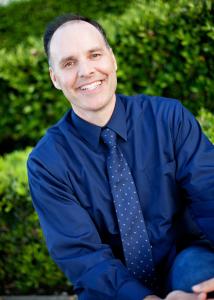 Dr. Steve Hall outdoors wearing buttoned shirt and tie