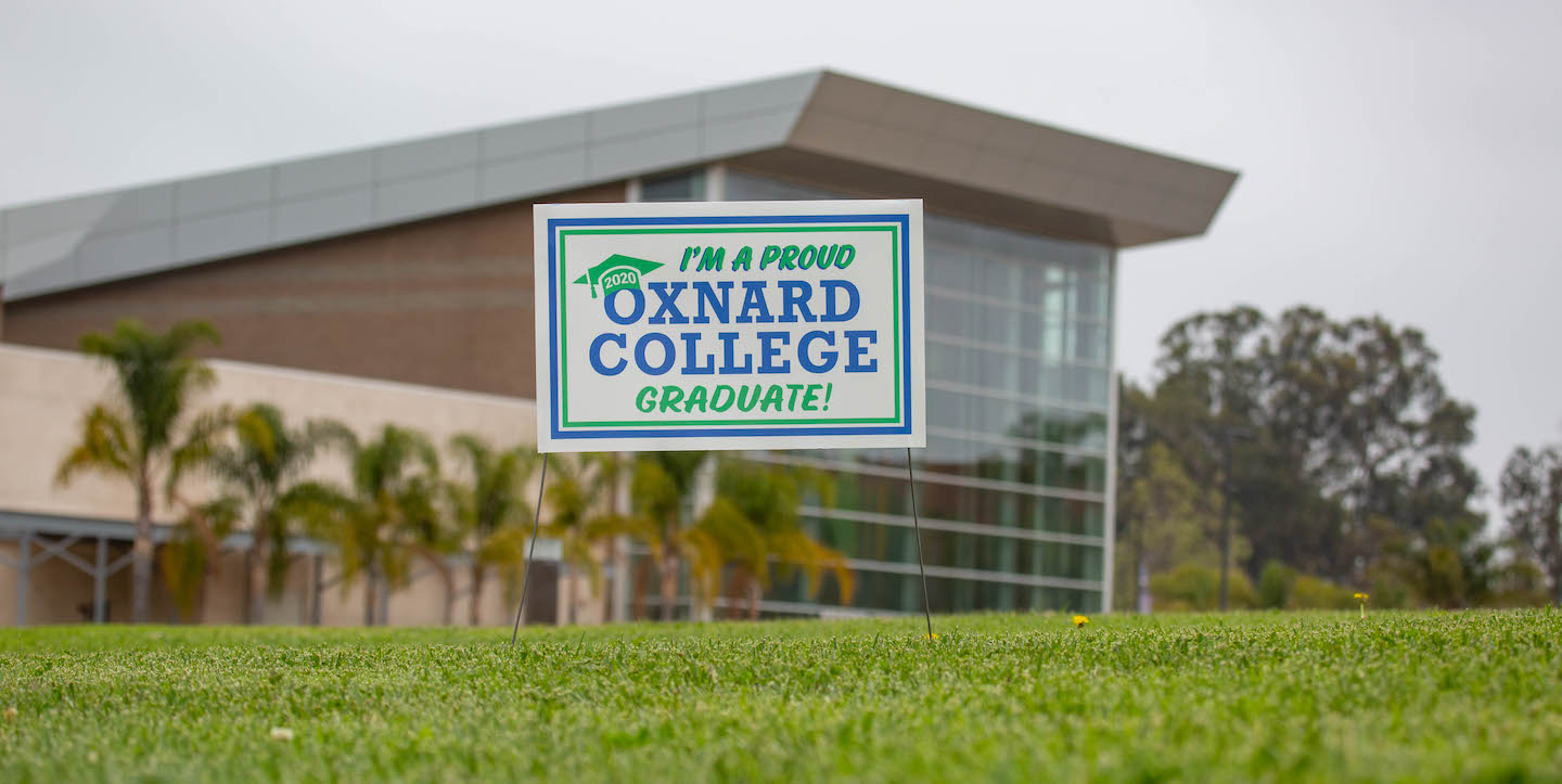 "I'm a proud oxnard college graduate!" Lawn sign shown in front of the Oxnard College Performing Arts Building.