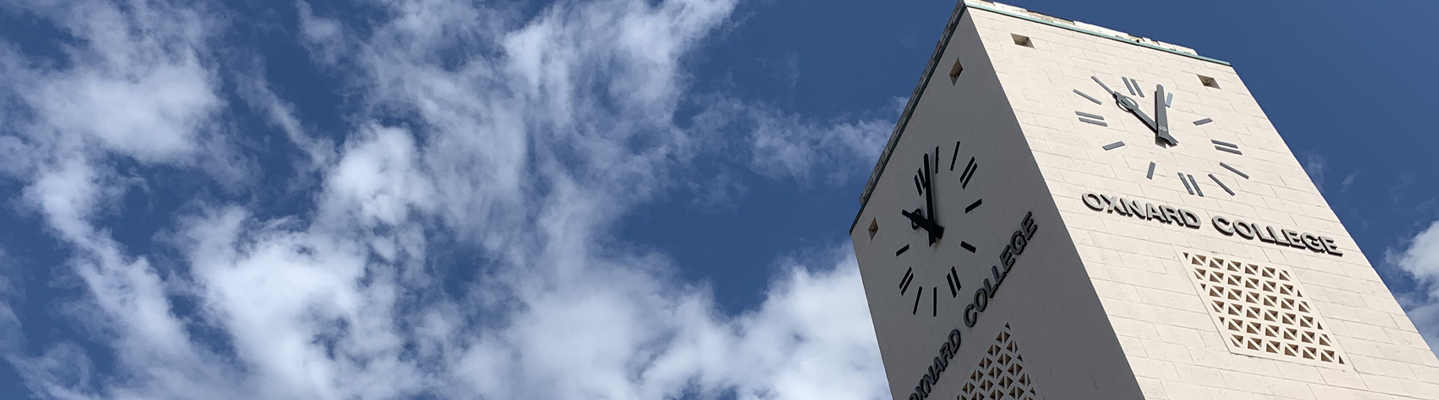 close up of clock tower with blue sky in background