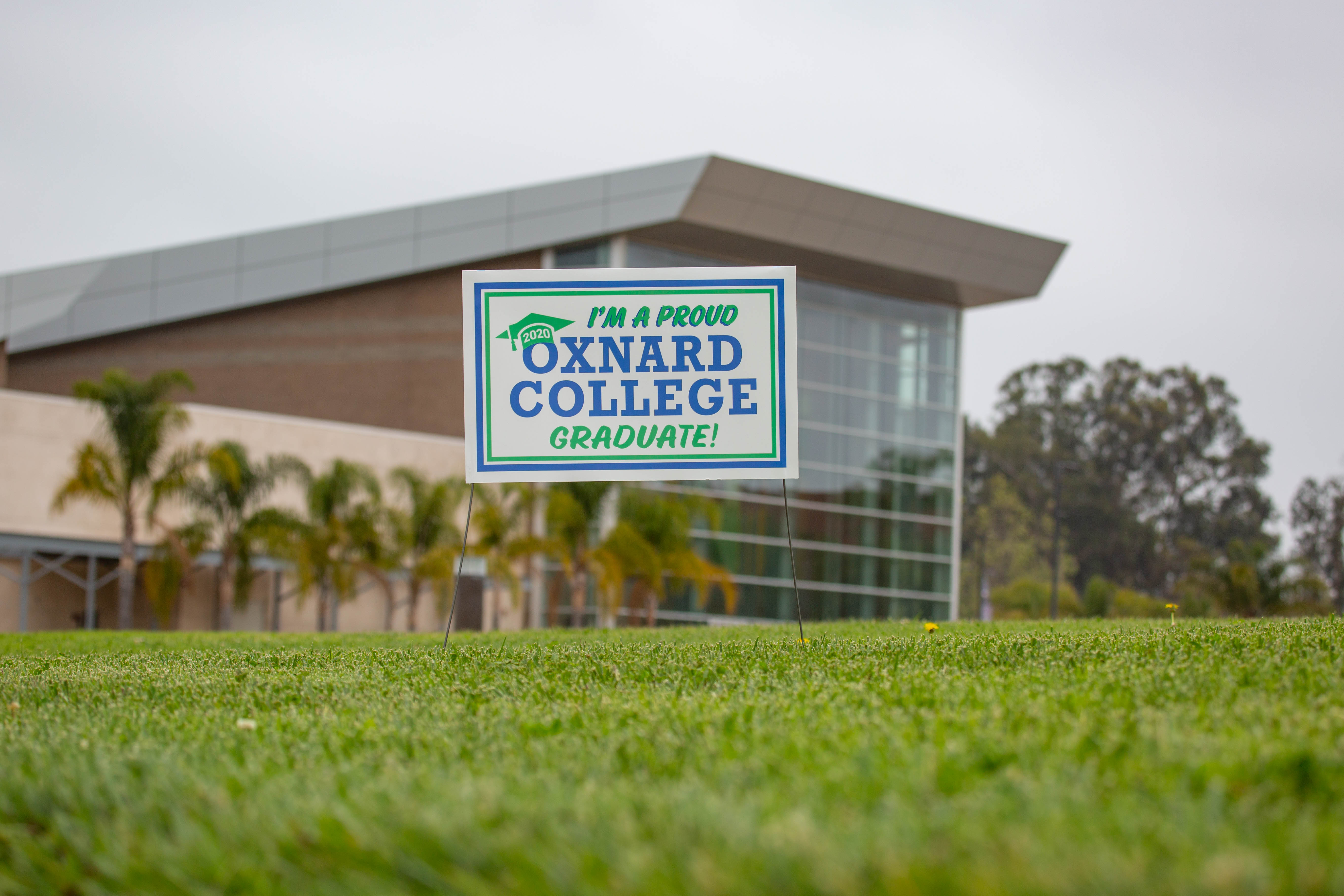 Oxnard College Graduate Sign in front of Oxnard College Performing Arts Building