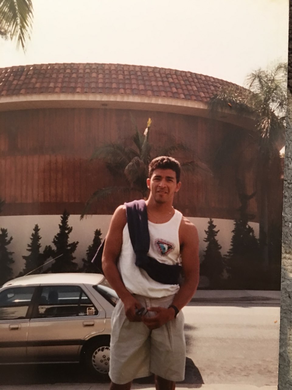 A young Rey Reyes standing outside.