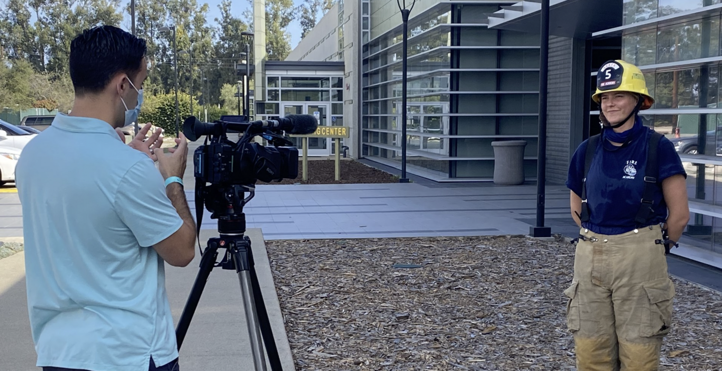 A person filming a fire academy cadet at the Oxnard College Fire Academy