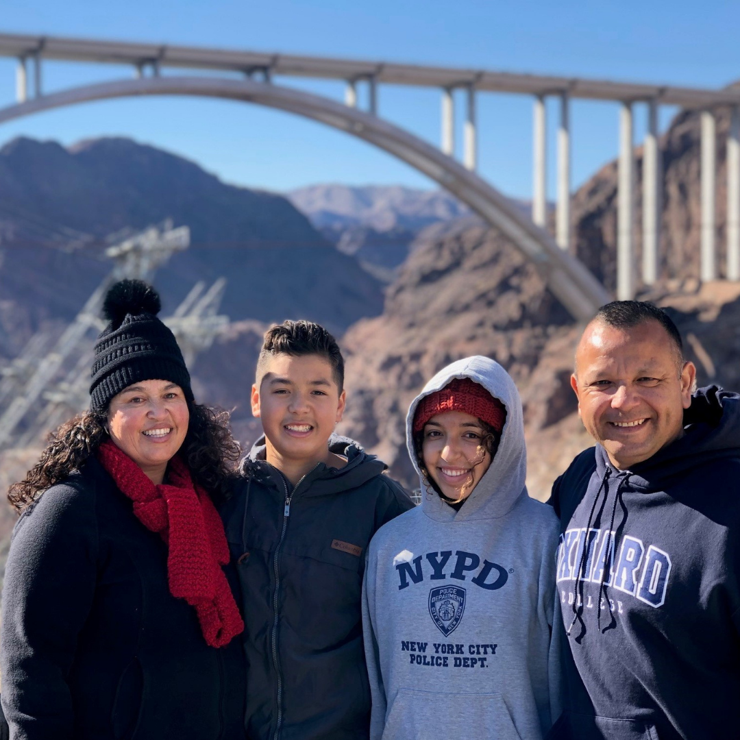 Image of Joel Diaz and Family Standing in front of a bridge