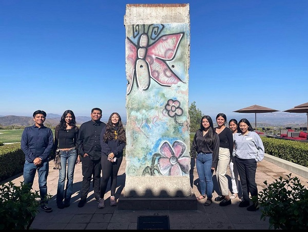 7 students standing in front of art exhibit