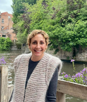 photo of Lisa Sandoval standing in front of a waterway with a tree in the background.