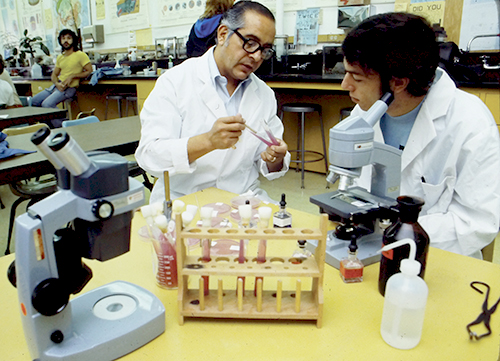 Oxnard College Retro Photo of Male Instructor working with male student in Science Class