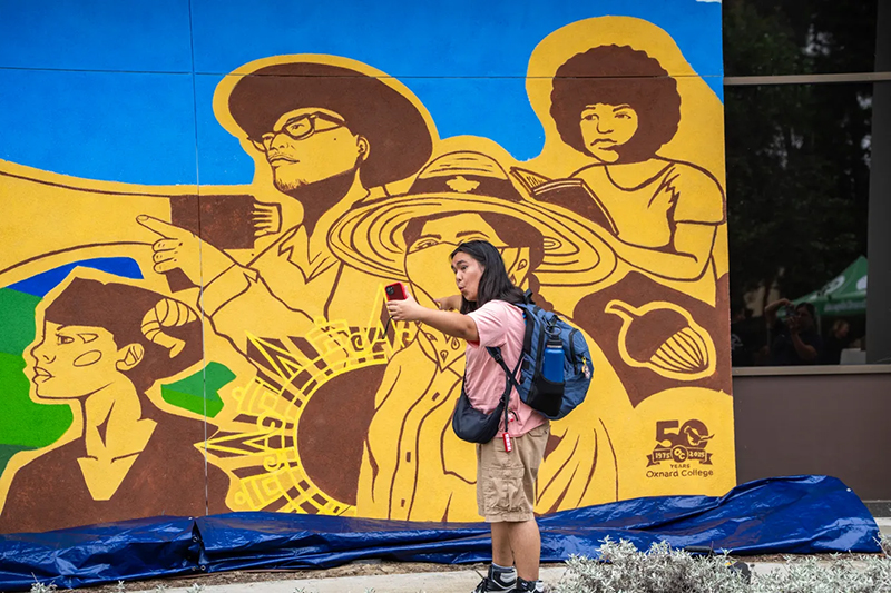 OC Student Taking Selfie with 50th Anniversary Mural