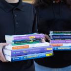 Students holding textbooks