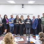 Classified Employee of the Year nominees stand holding plaqu