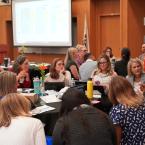 A group of educators and professionals are engaged in discus
