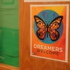 Sign on a door with a butterfly and the text "Dreamers Welcome"
