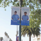 Light pole banners on C Street in Oxnard featuring two Oxnard College Public Safety graduates.