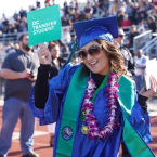 Oxnard College graduate holding a sign that reads: OC Transfer Student