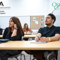 Photo of students sitting in class listening to a lecture and taking notes. Text reads "ABA American Bar Association, ABA Approved Paralegal Program; Oxnard College"