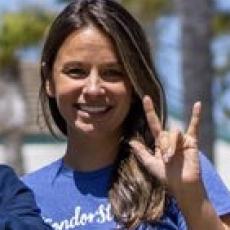 Emily Talbot signing the I Love You sign in ASL