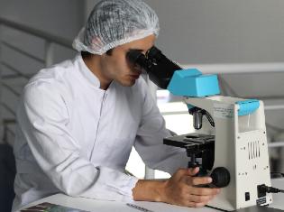 man looking into a microscope