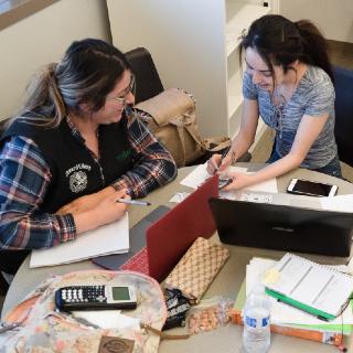 female tutor helping another student