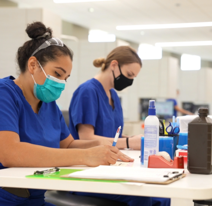 Two Dental Hygiene Students working in the Dental Lab