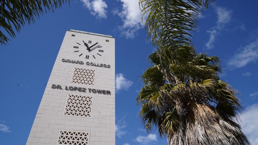 Oxnard College clock tower with palm trees in the foreground