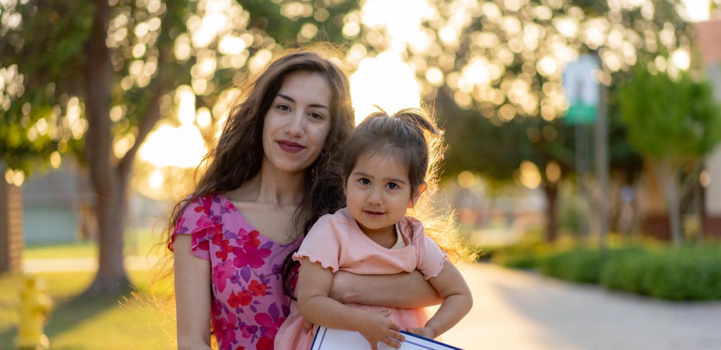 Student holding child