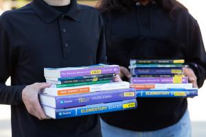 Students holding textbooks Students holding textbooks